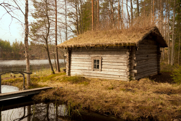Old wooden sauna house on the edge of a lake Old wooden sauna house on the edge of a lake