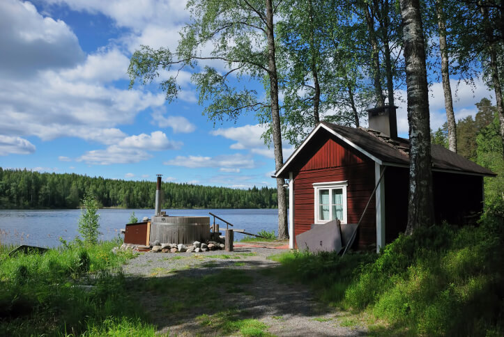 Red sauna hut typical of those found in Sweden and Finland build on the edge of a lake Red sauna hut typical of those found in Sweden and Finland build on the edge of a lake