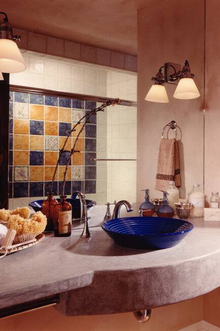 Close up of bathroom counter with blue vessel basin and tile work. Close up of bathroom counter with blue vessel basin and tile work.