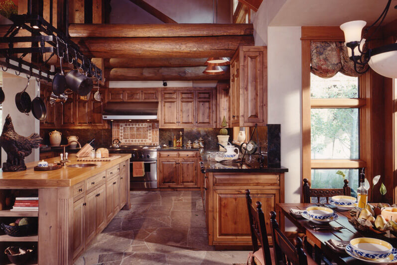Kitchen with extensive custom wood cabinets including large island. Useful pot rack above the island. Kitchen with extensive custom wood cabinets including large island. Useful pot rack above the island.