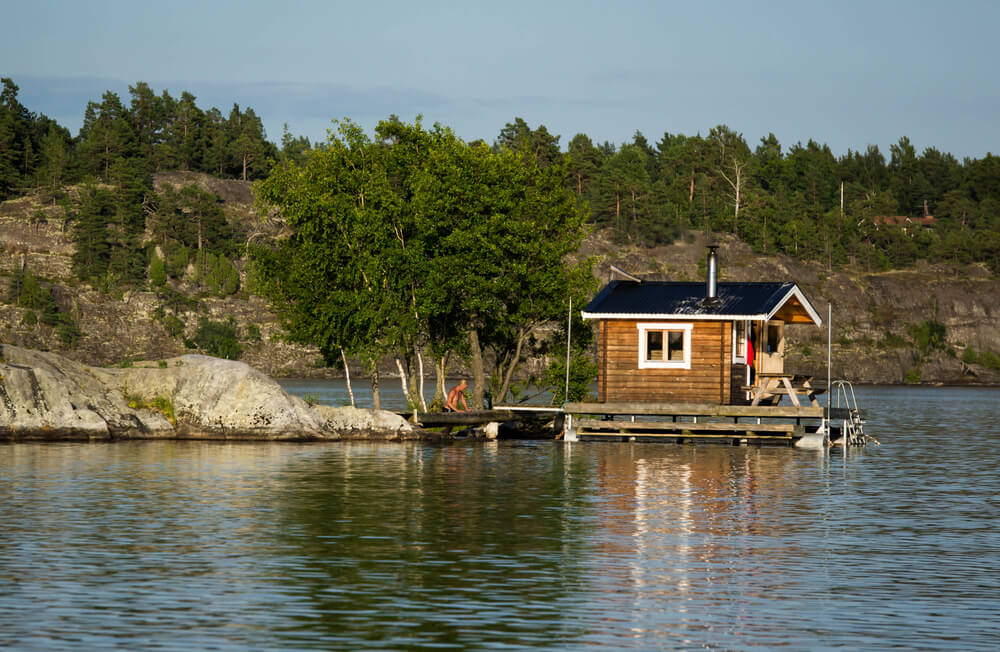 Sauna hut on dock floating on a lake Sauna hut on dock floating on a lake
