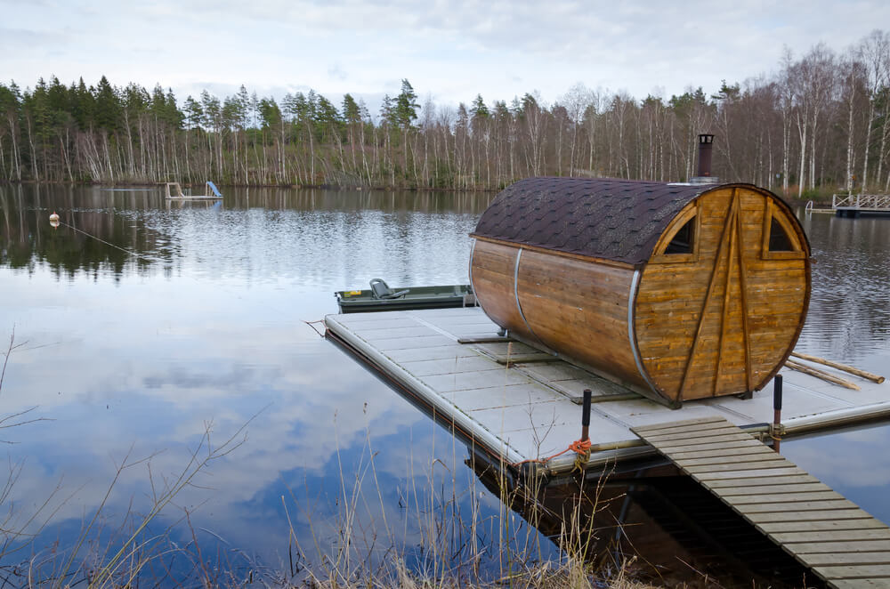Barrel sauna on a floating dock on a lake Barrel sauna on a floating dock on a lake
