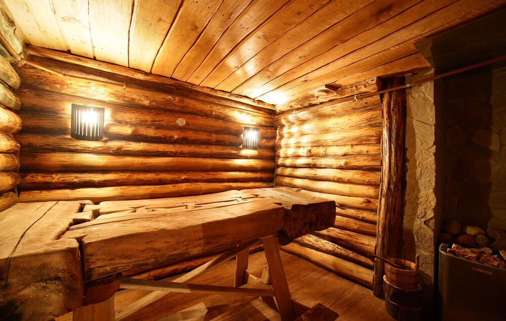 Traditional dry heat sauna in log hut with fold-down bench Traditional dry heat sauna in log hut with fold-down bench