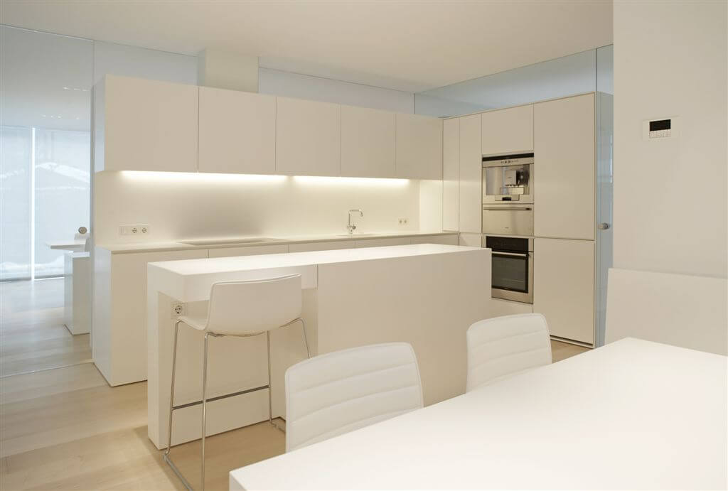 Here's a shot of the ultra modern kitchen, all-white with light hardwood flooring. Here's a shot of the ultra modern kitchen, all-white with light hardwood flooring.