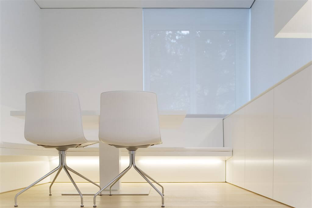 Close-up of corner office space. All-white theme continues. Close-up of corner office space. All-white theme continues.