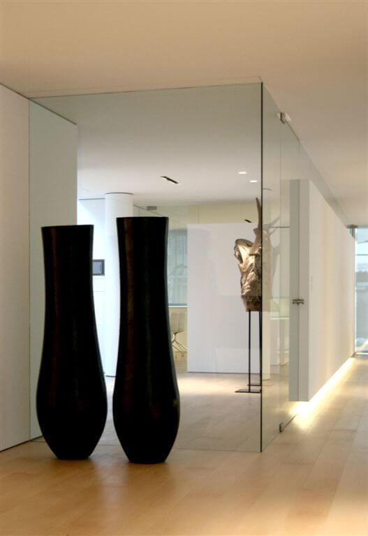 Second hallway angle showcasing glass walls, embedded lighting, and large art pieces. Second hallway angle showcasing glass walls, embedded lighting, and large art pieces.