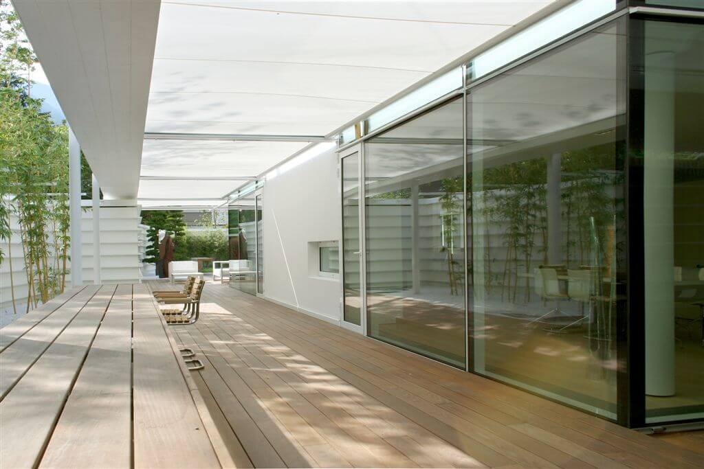 Long view of deck with canopy, glass walls and see-through fireplace. Long view of deck with canopy, glass walls and see-through fireplace.