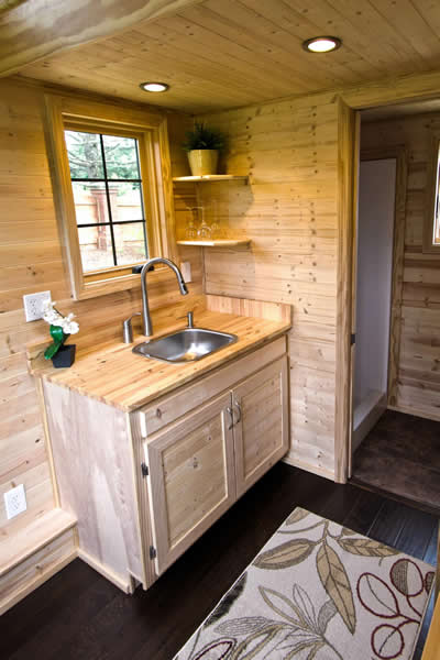 Opposite kitchen view highlighting sink area with window. Opposite kitchen view highlighting sink area with window.