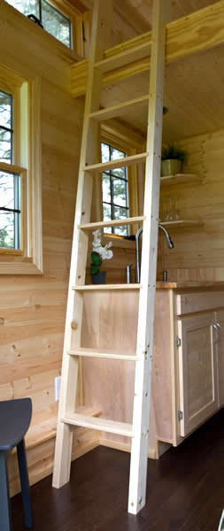 Interior is replete with natural unpolished wood, with ladder over kitchenette leading to loft. Interior is replete with natural unpolished wood, with ladder over kitchenette leading to loft.