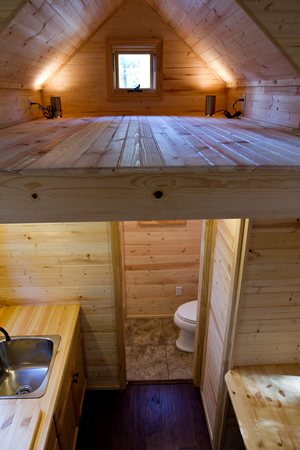 View of loft sleeping area above kitchenette, with small window and built in lighting. View of loft sleeping area above kitchenette, with small window and built in lighting.