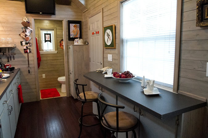 Bar style dining area sits across kitchenette. Bathroom in rear. Bar style dining area sits across kitchenette. Bathroom in rear.