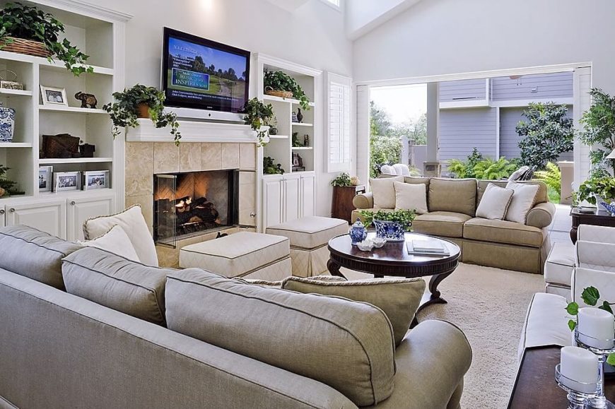 This living room is filled with seating, so a wealth of storage was built into the walls on either side of the elegant screened fireplace. This living room is filled with seating, so a wealth of storage was built into the walls on either side of the elegant screened fireplace.