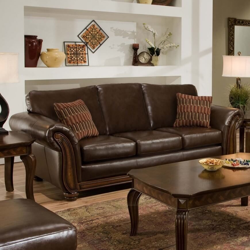 A sleek brown leather sofa with accent pillows. When paired with dark wooden tables, a lighter brown rug and light, neutral walls, the rich chocolate color stands out in an elegant way. A sleek brown leather sofa with accent pillows. When paired with dark wooden tables, a lighter brown rug and light, neutral walls, the rich chocolate color stands out in an elegant way.