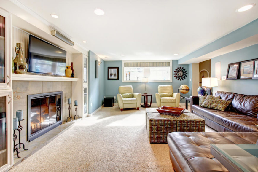 A soft, yet vibrant blue is used on two of the walls in this lengthy family room. While a bright color like this might get oppressive in a very large room with a lot of open wall space, this room features a lot of built-ins that help break up the color. A soft, yet vibrant blue is used on two of the walls in this lengthy family room. While a bright color like this might get oppressive in a very large room with a lot of open wall space, this room features a lot of built-ins that help break up the color.