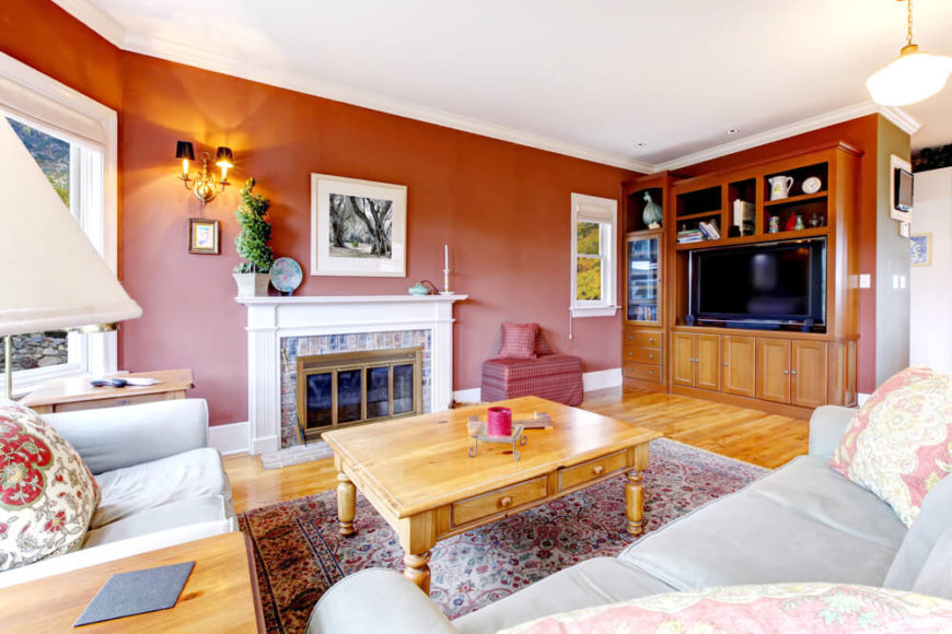 Even a rusty brick red can look great in the right design. When paired with light furniture and a rich light honey oak floor and tables, the red is warm and inviting. Even a rusty brick red can look great in the right design. When paired with light furniture and a rich light honey oak floor and tables, the red is warm and inviting.