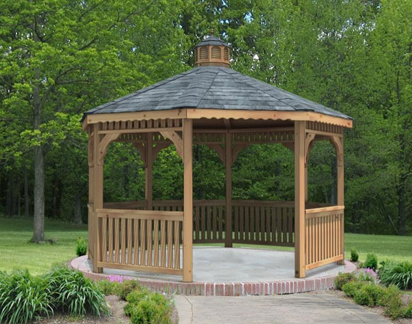 Octagonal gazebos keep that classic shape. This wooden example is sitting on a concrete pad rimmed by brick pavers. Octagonal gazebos keep that classic shape. This wooden example is sitting on a concrete pad rimmed by brick pavers.