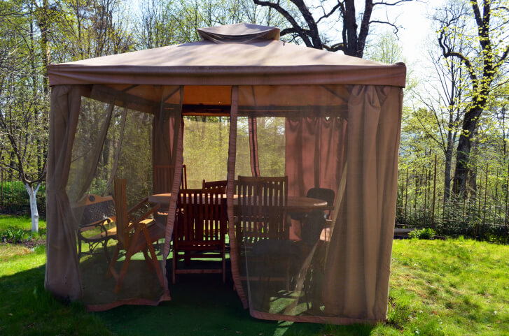 Screened gazebos like this one have the option of curtains for privacy. Much like a tent, this gazebo has fabric "walls." Screened gazebos like this one have the option of curtains for privacy. Much like a tent, this gazebo has fabric "walls."