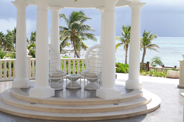 Another lovely round gazebo overlooking a tropical sea and palm trees. This style is small, so it only has room for a couple of chairs. This does, however, make for an intimate atmosphere. Another lovely round gazebo overlooking a tropical sea and palm trees. This style is small, so it only has room for a couple of chairs. This does, however, make for an intimate atmosphere.