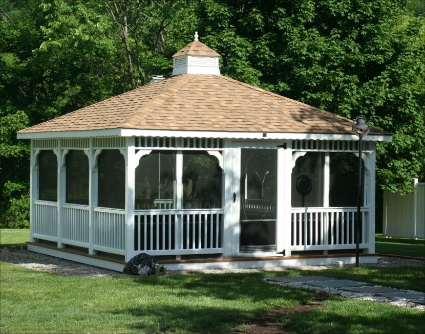 An enormous screened in rectangular gazebo at the end of a gravel and flagstone pathway. An enormous screened in rectangular gazebo at the end of a gravel and flagstone pathway.