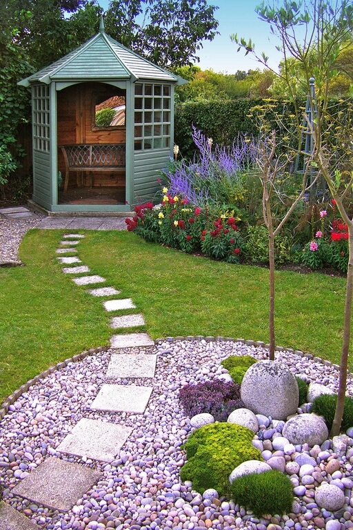 A gorgeous green gazebo that is secluded at the edge of the yard and contains a small bench. The space is small and intimate. A gorgeous green gazebo that is secluded at the edge of the yard and contains a small bench. The space is small and intimate.