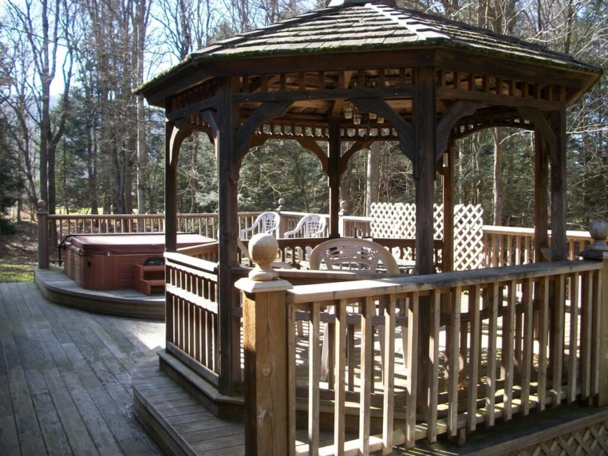This gazebo is placed on its own wooden platform, raised up about a foot from the main deck. The hot tub across from it is given the same treatment This gazebo is placed on its own wooden platform, raised up about a foot from the main deck. The hot tub across from it is given the same treatment