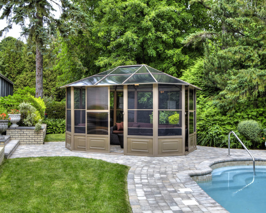 A glass roof makes an enclosed gazebo the perfect unattached solarium for a backyard. Here, it's next to a lovely pool. A glass roof makes an enclosed gazebo the perfect unattached solarium for a backyard. Here, it's next to a lovely pool.