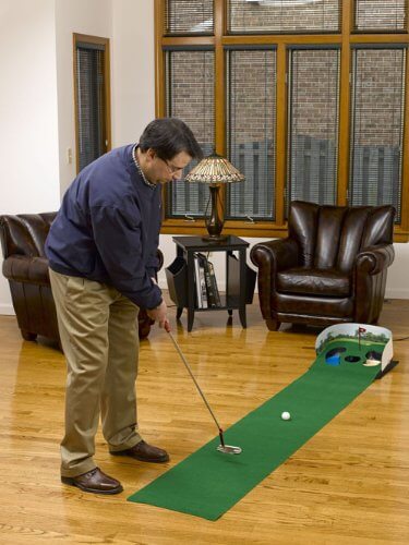 Here's a similar rolled-surface putting green, meant for portability and placement in any space with room and a flat surface. This example features two small hazards flanking the hole. Here's a similar rolled-surface putting green, meant for portability and placement in any space with room and a flat surface. This example features two small hazards flanking the hole.
