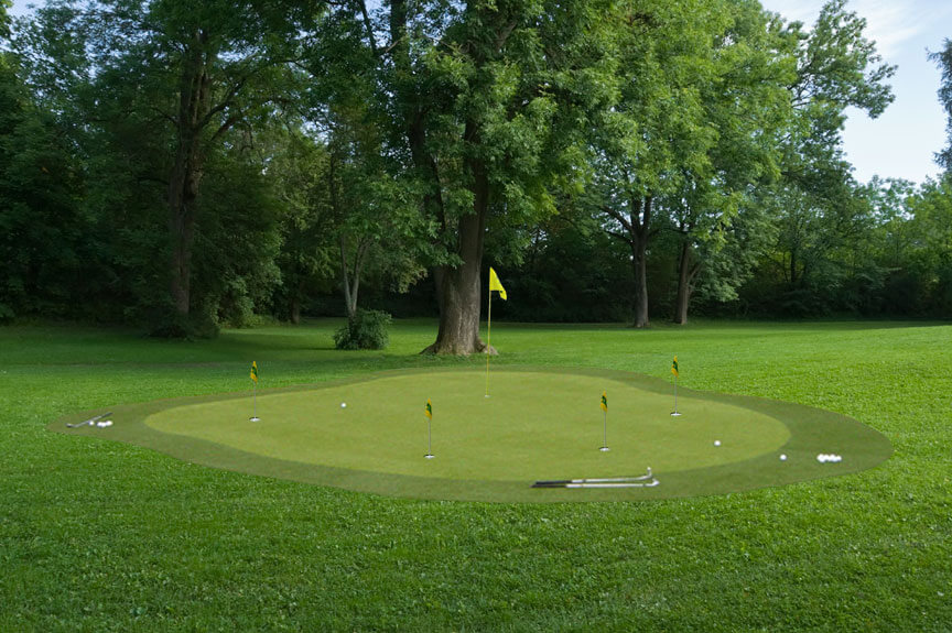 Here's a sprawling, lush lawn with this professional looking green resting at the center. Subtly rolling surface includes multiple holes and is shaded by nearby hardwood trees. Here's a sprawling, lush lawn with this professional looking green resting at the center. Subtly rolling surface includes multiple holes and is shaded by nearby hardwood trees.