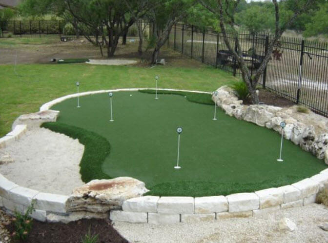 Unique green situated in raised stone barrier, integrating natural stone features on border. Features multiple holes and approaches, plus full sand trap. Unique green situated in raised stone barrier, integrating natural stone features on border. Features multiple holes and approaches, plus full sand trap.