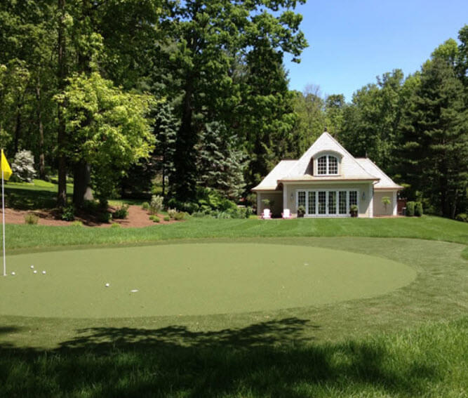 Circular natural green lays at the end of this sprawling lawn, surrounded by forest. Multiple holes offer variety and replay time. Circular natural green lays at the end of this sprawling lawn, surrounded by forest. Multiple holes offer variety and replay time.