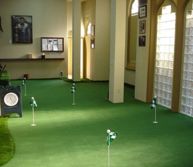 This indoor putting green incorporates an entire room, with pillars as hazards, an exterior wall defining the edge, and multiple holes and approaches. This indoor putting green incorporates an entire room, with pillars as hazards, an exterior wall defining the edge, and multiple holes and approaches.