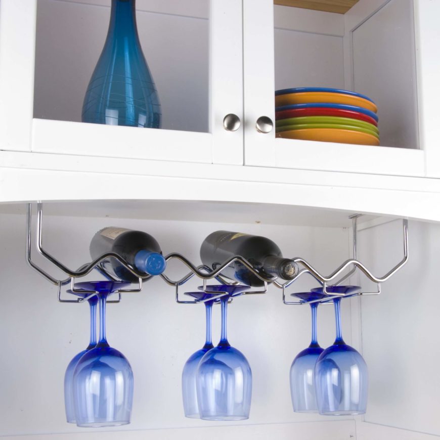 Hanging wine racks are another perfect way to conserve space. This first model is mounted beneath cabinetry, and with its simple wire frame, holds both bottles and glassware. Hanging wine racks are another perfect way to conserve space. This first model is mounted beneath cabinetry, and with its simple wire frame, holds both bottles and glassware.