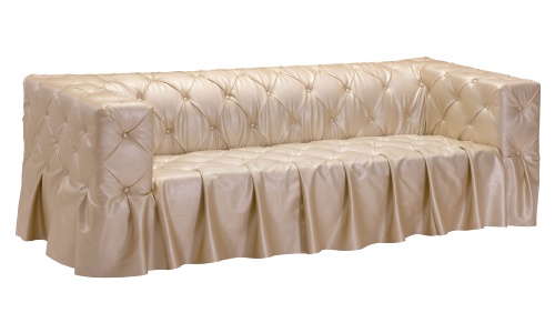 This is a daringly comfortable and stylish sofa in a rich gold faux leather upholstery that is covered in button tufting. The seamless skirt, which is just an extension of the upholstery, gives this piece an extra elegant polish. This is a daringly comfortable and stylish sofa in a rich gold faux leather upholstery that is covered in button tufting. The seamless skirt, which is just an extension of the upholstery, gives this piece an extra elegant polish.