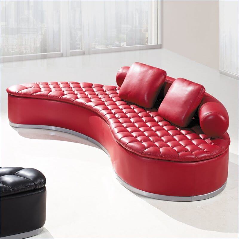 Another elegant, bold and ultra comfortable option is this bright red kidney-shaped sectional sofa, complete with biscuit tufting detail on the seat and a rounded backrest. The upholstery is a rich bonded leather. Another elegant, bold and ultra comfortable option is this bright red kidney-shaped sectional sofa, complete with biscuit tufting detail on the seat and a rounded backrest. The upholstery is a rich bonded leather.