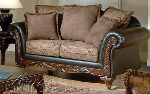 This majestic and elegant sofa combines a subtle floral pattern with sleek expresso leather and a rich dark hardwood frame. The frame features hand-carved leaf scroll carvings in the French Provincial style. This majestic and elegant sofa combines a subtle floral pattern with sleek expresso leather and a rich dark hardwood frame. The frame features hand-carved leaf scroll carvings in the French Provincial style.