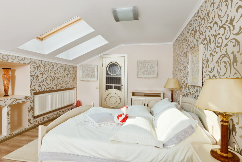 A mid-century modern bedroom in bold wallpaper and a uniquely detailed door leading out of the space. Built-in cubby holes in the shorter wall provide storage without large furniture. A mid-century modern bedroom in bold wallpaper and a uniquely detailed door leading out of the space. Built-in cubby holes in the shorter wall provide storage without large furniture.