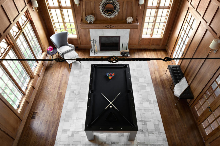 An aerial view of the den, showing the small seating area next to the fireplace and a bench on the right wall.