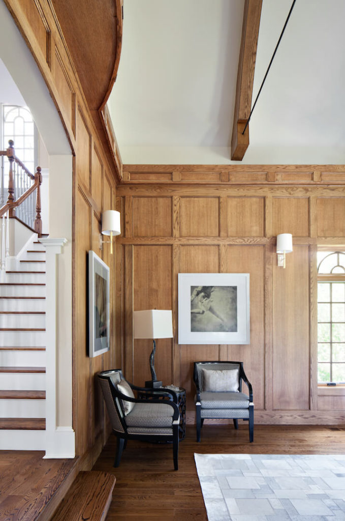 On the left when you enter the room is another small seating area with two chairs. Visible to the left of the frame is the staircase in the foyer.