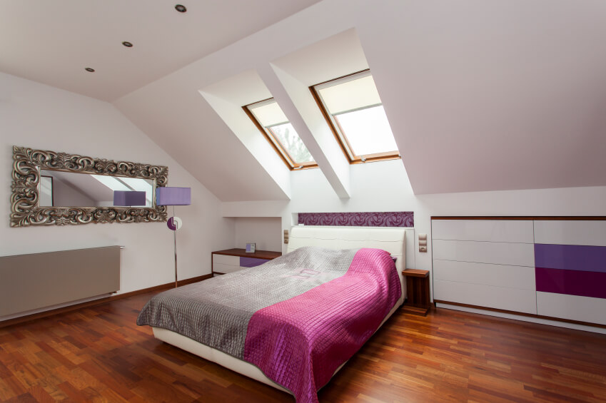 A bold bedroom in shades of magenta, violet, and silver. The heavy filigree around the mirror on the left side of the room adds bold elegance. A bold bedroom in shades of magenta, violet, and silver. The heavy filigree around the mirror on the left side of the room adds bold elegance.