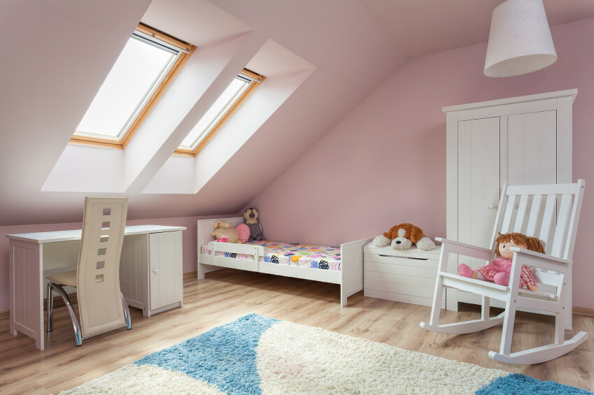 A sweet child's room in pale pink and white. The rocking chair appears to be oversized in comparison with the miniature bed tucked into the corner. A sweet child's room in pale pink and white. The rocking chair appears to be oversized in comparison with the miniature bed tucked into the corner.