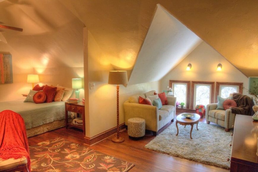 Tucked into one corner, the bedroom has a bit of privacy by way of an extension of the living room wall. Vaulted ceilings create a living room nook, complete with a love seat, coffee table, and chair. Tucked into one corner, the bedroom has a bit of privacy by way of an extension of the living room wall. Vaulted ceilings create a living room nook, complete with a love seat, coffee table, and chair.
