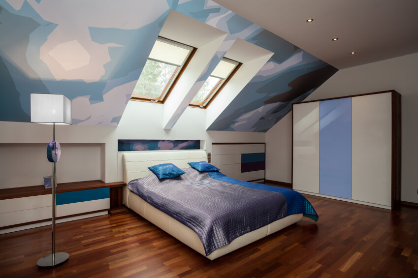 A computer-generated image of a bedroom features graphic wall art, color-blocking, and a cream leather platform bed. A computer-generated image of a bedroom features graphic wall art, color-blocking, and a cream leather platform bed.