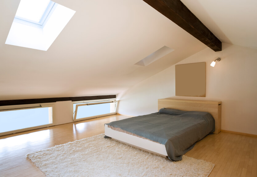 Hopper windows and a softly angled ceiling accentuate the arch of this bedroom. Clean lines and a soft rug continue the minimalist theme of slim, low-profile furniture and natural materials. Hopper windows and a softly angled ceiling accentuate the arch of this bedroom. Clean lines and a soft rug continue the minimalist theme of slim, low-profile furniture and natural materials.