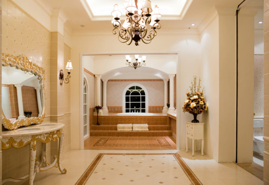 Extravagant doesn't even begin to describe this luxurious bathroom. Skylights assist hanging chandeliers to brighten this gorgeous space. Details such as gold gilded mirrors, varied tile work and patterns, and the professionally designed bouquet of brown and cream roses hint that no expense was spared in the creation of this phenomenal space. Extravagant doesn't even begin to describe this luxurious bathroom. Skylights assist hanging chandeliers to brighten this gorgeous space. Details such as gold gilded mirrors, varied tile work and patterns, and the professionally designed bouquet of brown and cream roses hint that no expense was spared in the creation of this phenomenal space.