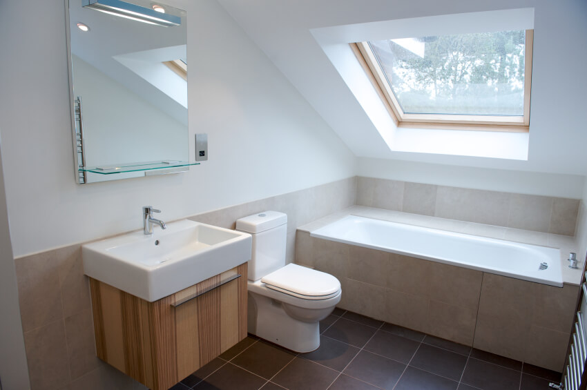 This minimalist bathroom features clean lines, modern design, and a large skylight to lend daily sunshine to this smaller area. This minimalist bathroom features clean lines, modern design, and a large skylight to lend daily sunshine to this smaller area.
