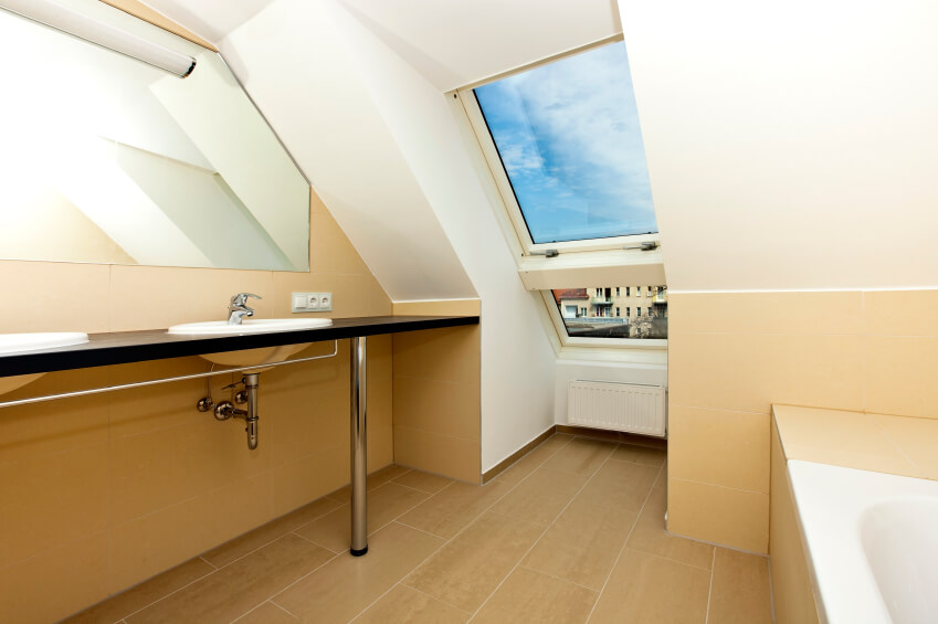 The above skylight offers a gorgeous blue sky with cottony clouds, while the rest of the bathroom delights in angles, minimalist design, and the buttery richness of its walls. The above skylight offers a gorgeous blue sky with cottony clouds, while the rest of the bathroom delights in angles, minimalist design, and the buttery richness of its walls.