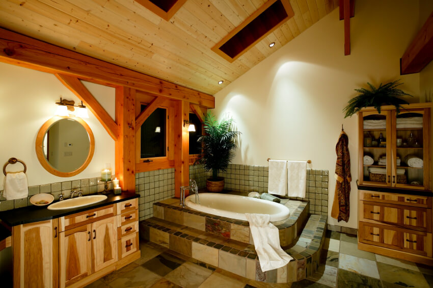Another shot of the previous bathroom reveals patchwork tiling and strong rustic beams. Additional multi-tonal storage is noted, while more skylights promise a flood of light by day. Another shot of the previous bathroom reveals patchwork tiling and strong rustic beams. Additional multi-tonal storage is noted, while more skylights promise a flood of light by day.