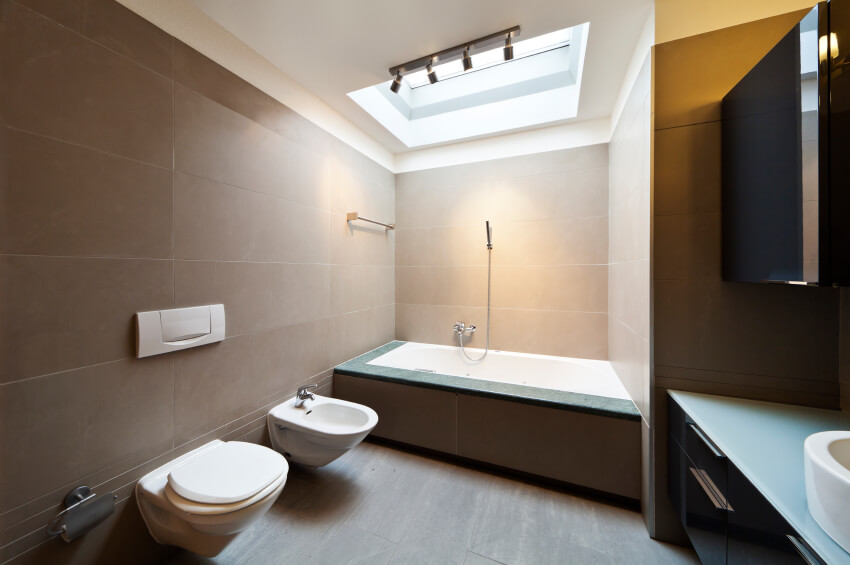 A gorgeous skylight allows the bathing area to glow in natural light in this modern minimalist space. A gorgeous skylight allows the bathing area to glow in natural light in this modern minimalist space.