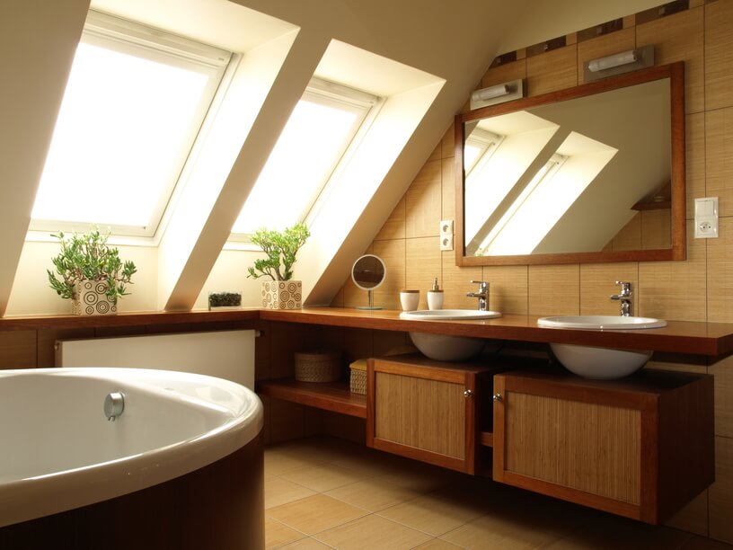 The double skylights featured above cast a comforting haze of light onto this exquisitely designed bathroom. Deep porcelain sinks are inset into a fine wood cabinet, and rest upon bamboo and wood storage cabinets beneath. A large mirror reflects the light gleaned from the skylights, maximizing the available natural light and further brightening the space. The double skylights featured above cast a comforting haze of light onto this exquisitely designed bathroom. Deep porcelain sinks are inset into a fine wood cabinet, and rest upon bamboo and wood storage cabinets beneath. A large mirror reflects the light gleaned from the skylights, maximizing the available natural light and further brightening the space.