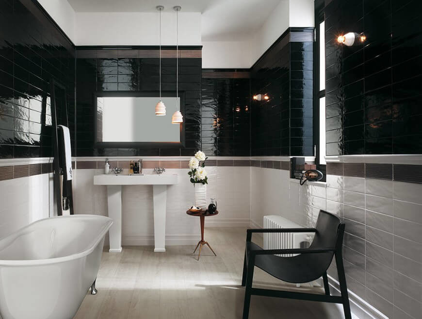 This bathroom is full of polished tile that contrasts elegantly with one another. The light wooden flooring also adds to this fierce color scheme of dark and light hues. This bathroom is full of polished tile that contrasts elegantly with one another. The light wooden flooring also adds to this fierce color scheme of dark and light hues.